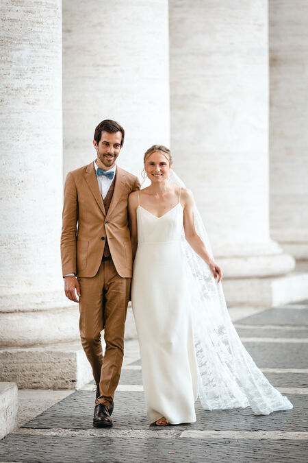 Newly-weds posing under the Colonnade in St. Peter's Square in Rome