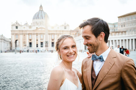 Happy newly-weds smiling with the Vatican in the background during their Sposi Novelli photo shoot