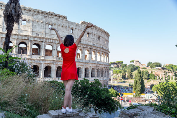 Girl in a red dress on a Vacation Photo Session on Colle Oppio, Colosseum, Rome