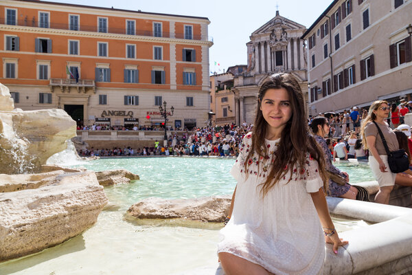 Portrait of a girl in a white dress during her fun Vacation Photo Session in Rome with ShootRome