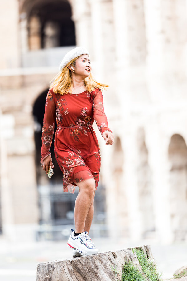 Fashion Photo shoot at the Colosseum with a bubbly girl in a red dress