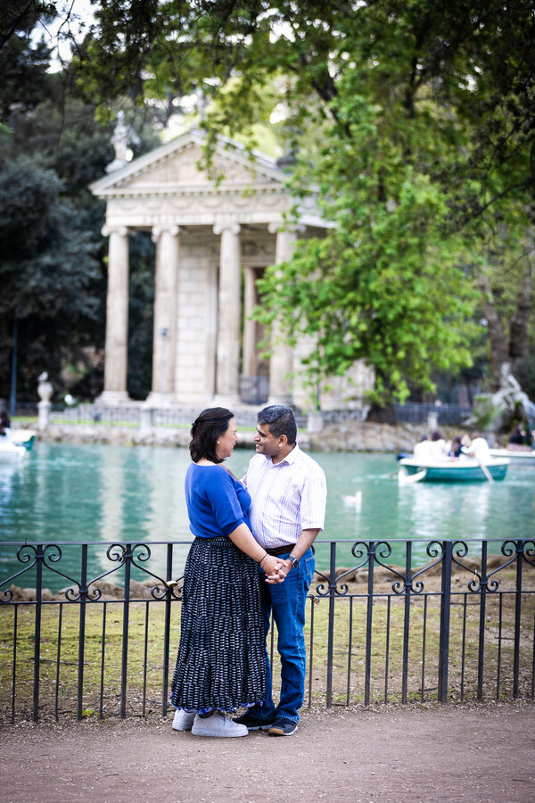Couple holding hands at the Temple of Asclepius in Villa Borghese in Rome