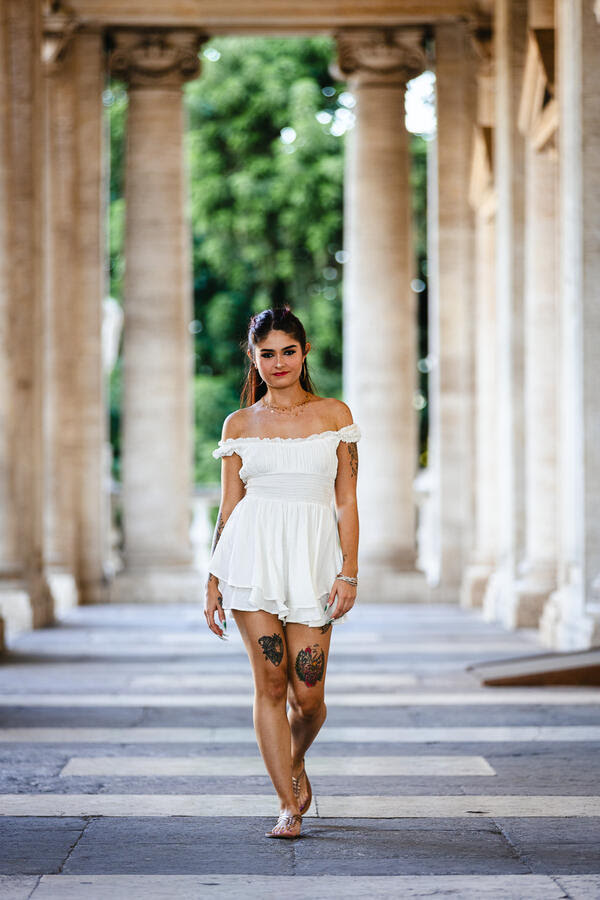 Girl walking under the colonnade on the Capitoline Hill during her Solo Traveller Photoshoot in Rome
