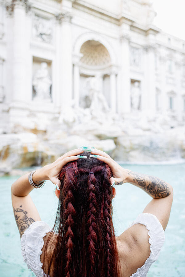 Female Solo Traveller at the Trevi Fountain at sunrise in Rome