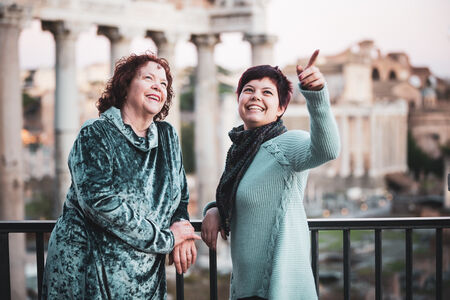 Smiling mother and daughter during their family photo session at the Roman Forum viewpoint on the Capitoline Hill