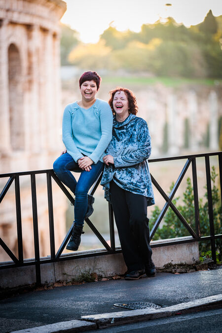 Mother and daughter laughing during their family photo shoot at the Colosseum