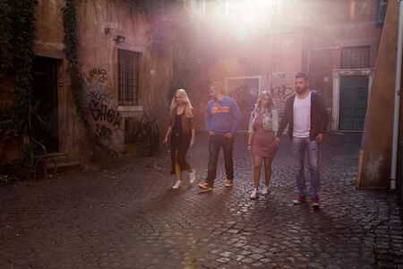 A group of friends walking in Trastevere, Rome