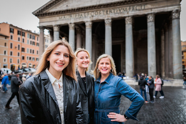 Younger daughter posing for the camera with mother and sister in the background at the Pantheon