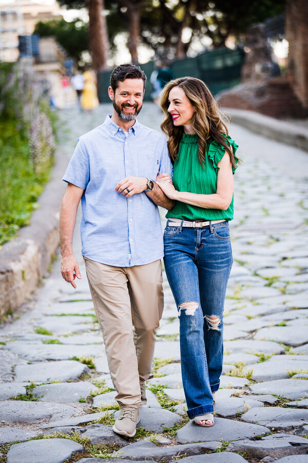 Mother and father walking together and smiling during their family photoshoot in Rome