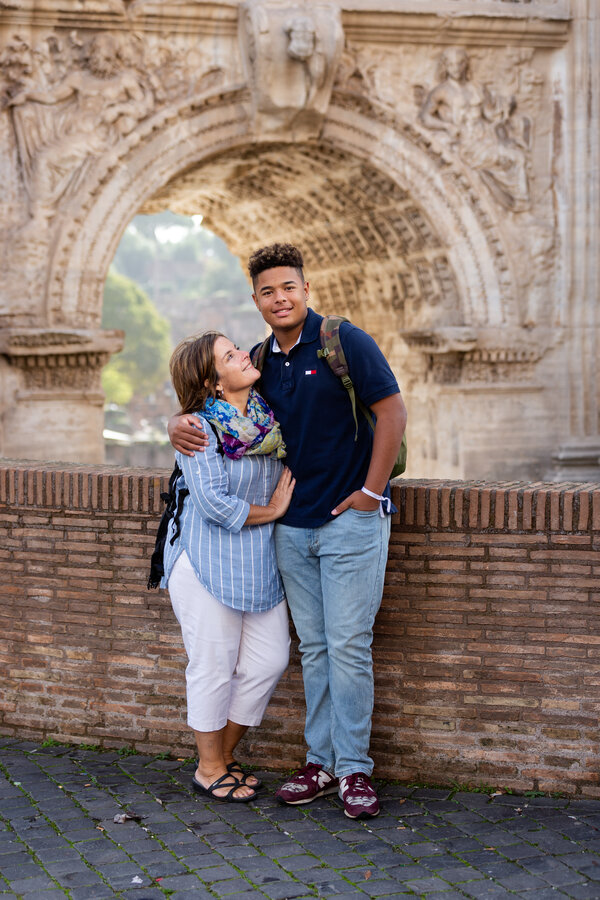 Mother and son during a Rome vacation photo shoot with the Septimius Severus Arch in the background