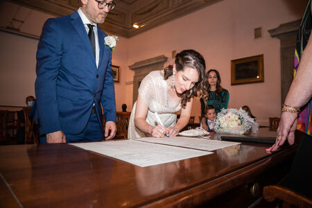 Bride signing the wedding papers during a civil ceremony
