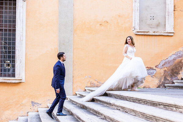 Wedding couple climbing the Staircase of the Protomoteca Hall on the Capitoline Hill