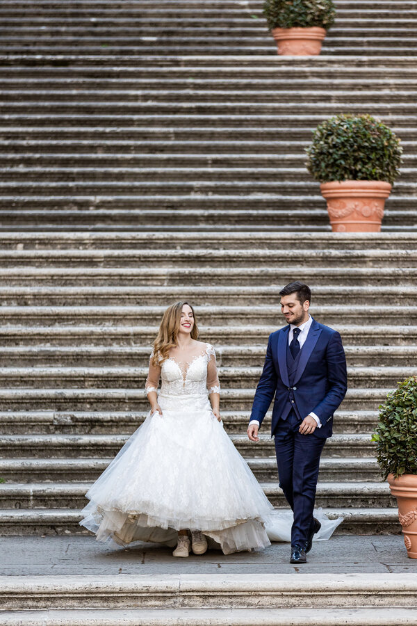 Elegant wedding couple on the staircase of the Protomoteca Hall on the Capitoline Hill