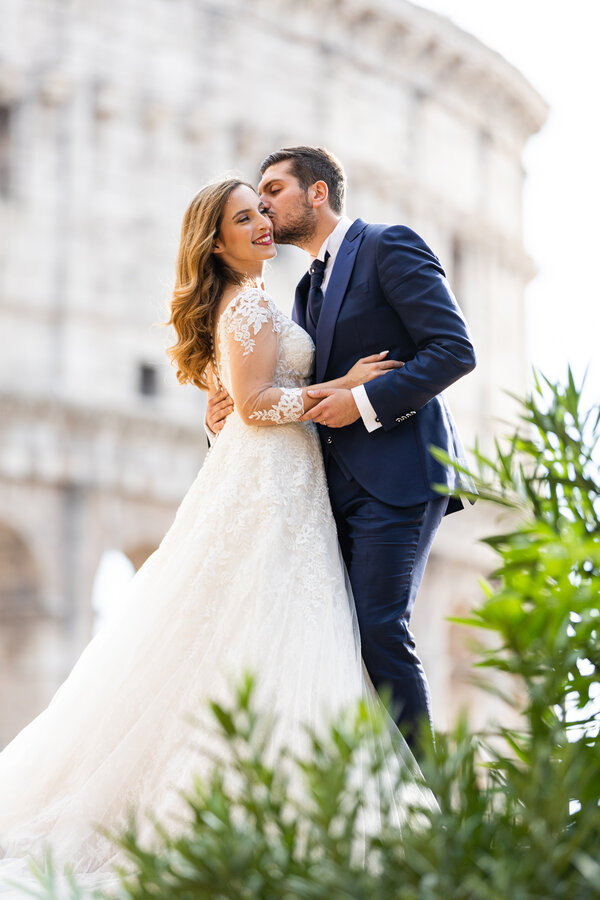Beautiful wedding couple with the Colosseum in the background
