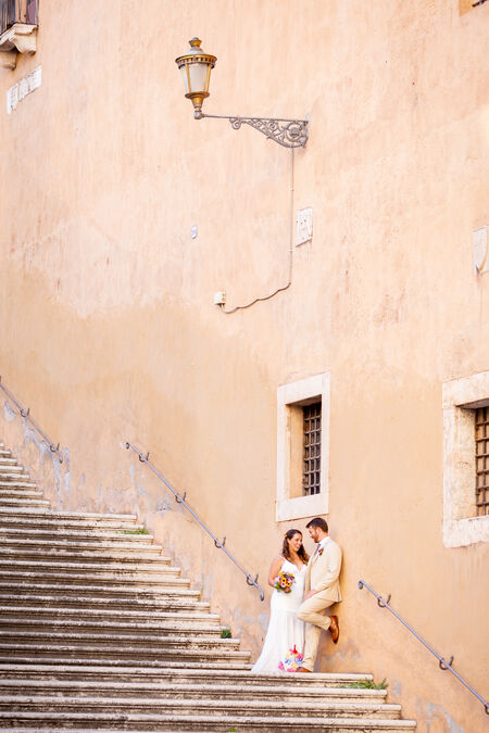 Newly-wed couple on a beautiful staircase on the Capitoline Hill in Rome