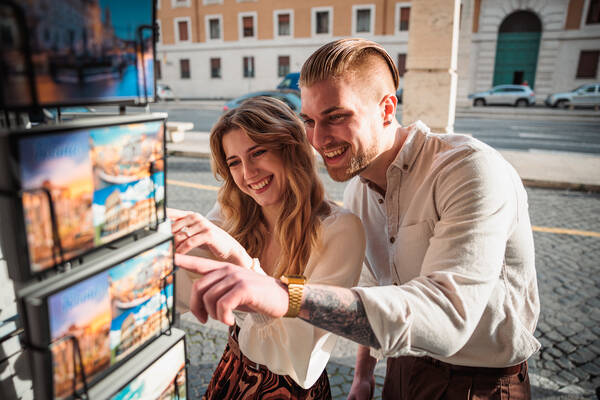 A beautiful young couple during their Engagement Photoshoot in Rome from Castel Sant'Angelo Bridge to Saint Peter's Square