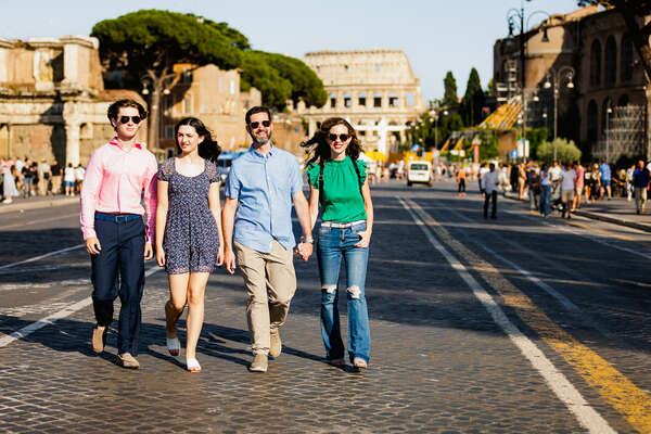 Family of 4 walking down Via dei Fori Imperiali during their Family Photo Shoot at the Colosseum