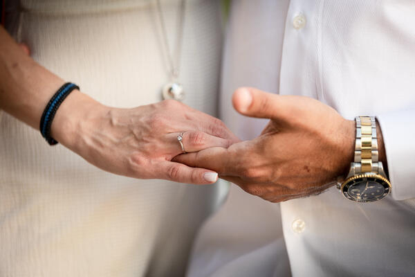 Close-up of newly-engaged couple holding hands during their surprise proposal in Rome
