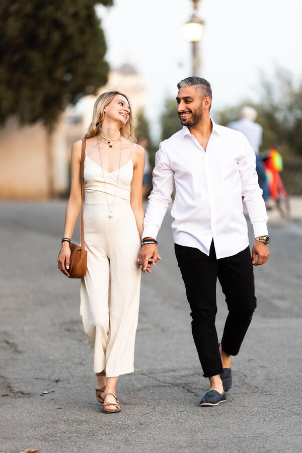 Newly-engaged couple walking on Terrazza Belvedere in Rome