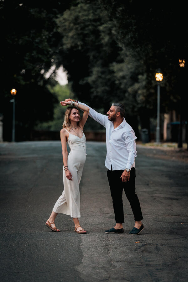 Newly-engaged couple dancing at the Pincio Gardens during their surprise proposal photo shoot in Rome