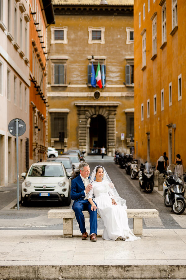 Sposi Novelli couple resting a bench along Via della Conciliazione in Rome