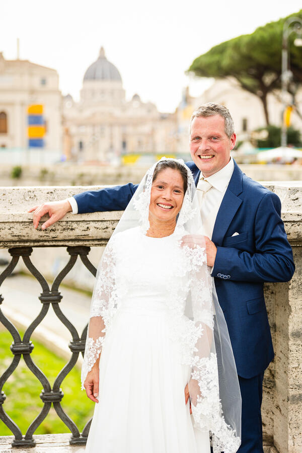 Beautiful Sposi Novelli couple smiling on Castel Sant'Angelo Bridge