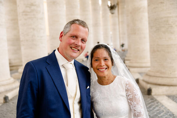 Smiling Sposi Novelli couple under the colonnade in Saint Peter's Square in Rome