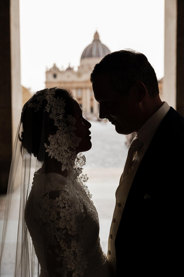Silhouette of Sposi Novelli couple with the Vatican in the background